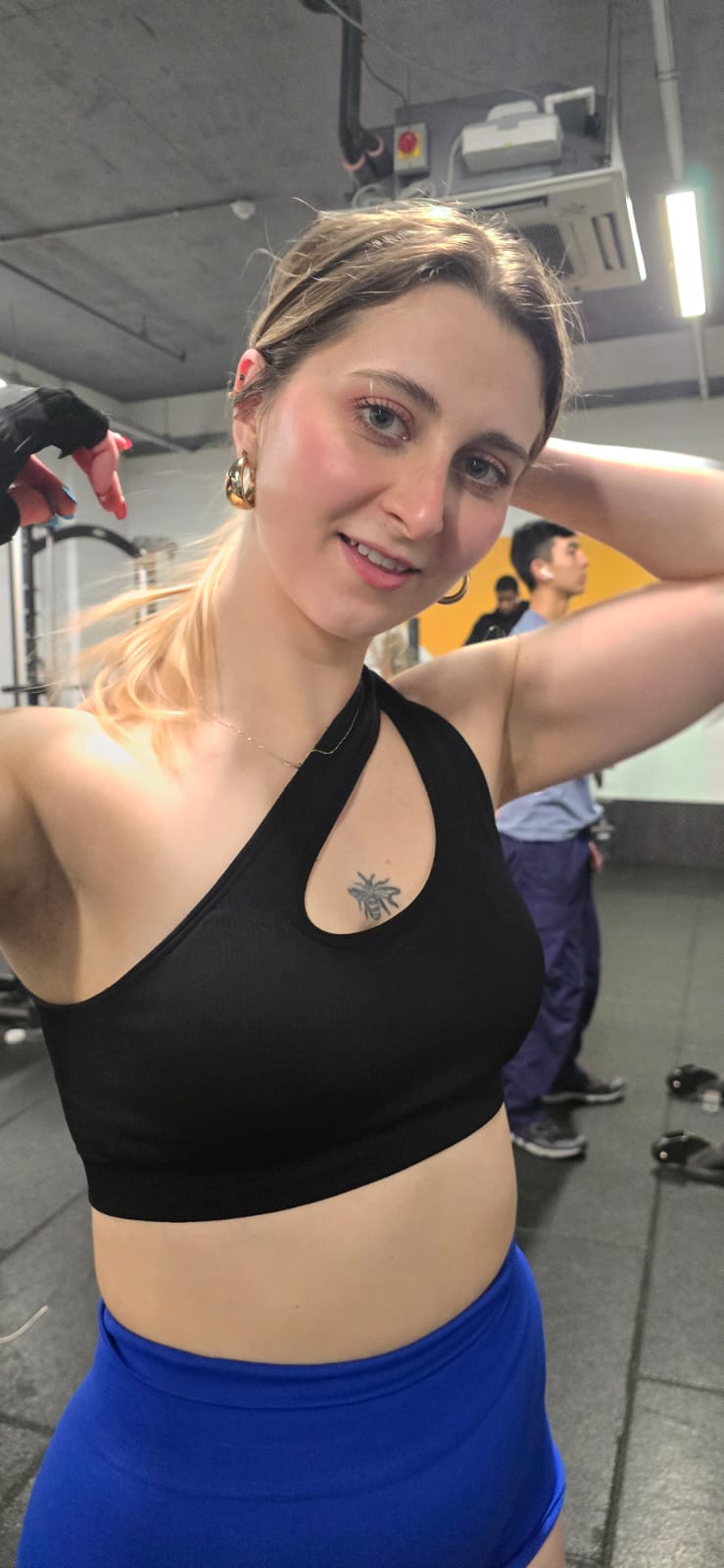Client smiling while showcasing shoulder progress